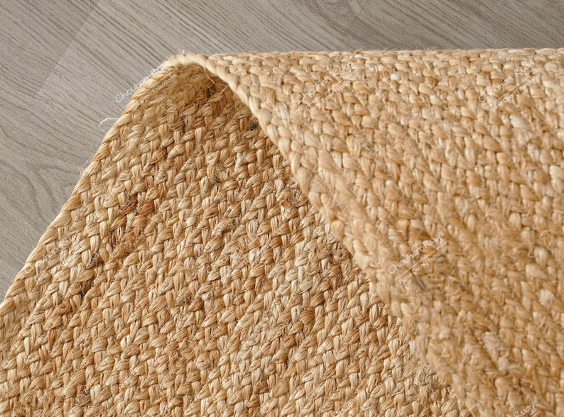 "Showcasing a timeless aesthetic, this hand-braided mat utilizes the natural golden hues of jute for a light, airy feel. The solid color and pronounced vertical texture make it effortlessly adaptable to various styles, including Coastal, Scandinavian, or Modern Farmhouse."