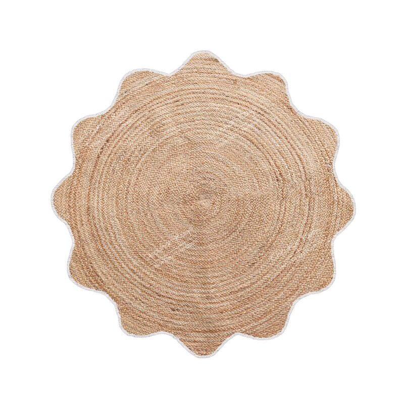 May include: A round, natural jute rug with a scalloped edge. The rug has a light brown color with a white trim along the edge. The rug's design features concentric circles, creating a textured appearance. This rug is suitable for indoor use.