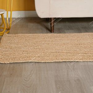 "An impressive example of sustainable home decor, this natural fiber runner offers a simple yet elegant solution for floor covering. The linear texture of the braids directs the eye and provides visual length, while the robust, thick construction guarantees long-lasting utility and rustic charm."