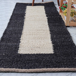Handwoven natural jute area rug with a off white center stripe, eco-friendly handmade rug designed for modern boho and farmhouse interiors. This rustic natural fiber floor rug adds warmth and texture to living rooms, bedrooms, hallways, or entryways. Durable artisan-crafted jute carpet with neutral tones that complement minimalist, Scandinavian, and contemporary home décor while bringing an organic, earthy look to any space. 🏡