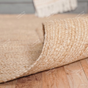 Close-up view of a hand-braided jute rug, highlighting the thick natural fibers and tightly woven texture for durable, eco-friendly flooring.