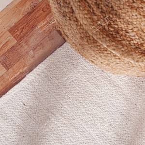"An example of sustainable home decor, this eco-friendly rug highlights the raw, organic charm of pure jute. The dense, vertical weave structure provides substantial durability and a wonderfully soft underfoot feel, proving that simplicity in design can achieve maximum impact in creating a tranquil, grounded interior."