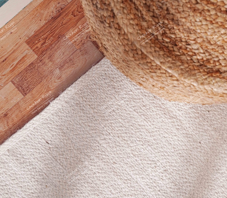 "An example of sustainable home decor, this eco-friendly rug highlights the raw, organic charm of pure jute. The dense, vertical weave structure provides substantial durability and a wonderfully soft underfoot feel, proving that simplicity in design can achieve maximum impact in creating a tranquil, grounded interior."