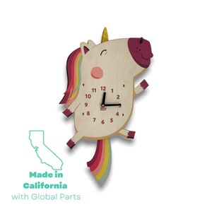 May include: A wooden unicorn wall clock with a rainbow mane and tail. The clock face is white with black hands and black numbers. The clock is made in California with global parts.
