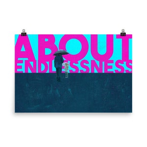 May include: A poster with the words "ABOUT ENDLESSNESS" in large pink letters against a blue background. Below, a dark blue section features a person with an umbrella and another person. The poster is held by two black binder clips.