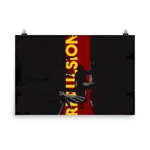 May include: A poster with a dark, textured background and a vertical red stripe. The word "REBELLION" is printed in yellow, with a silhouette of a person and other figures. The poster is held by two binder clips.