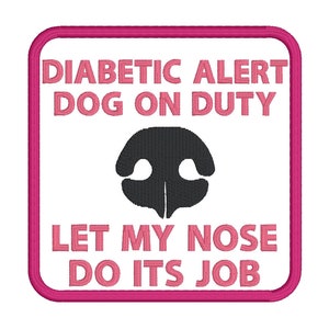 May include: A pink square patch with white text that reads "Diabetic Alert Dog on Duty Let My Nose Do Its Job". A black silhouette of a dog's nose is in the centre of the patch.