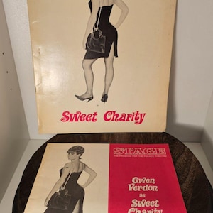 May include: Two vintage theater programs featuring Gwen Verdon in "Sweet Charity." The top program has a beige background with the title and actress's name in blue. The bottom program has a red background with the title and actress's name in white.