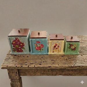 May include: A set of four square canisters with dark brown wooden lids and small round knobs. Each canister features a different pastel base color—light blue, teal, pale yellow, and sage green—and is decorated with floral illustrations.