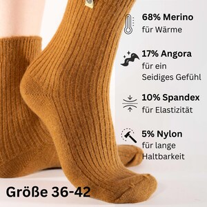 May include: Brown ribbed socks made with 68% merino wool, 17% angora, 10% spandex, and 5% nylon. The socks are shown on a model's feet and the size is 36-42.