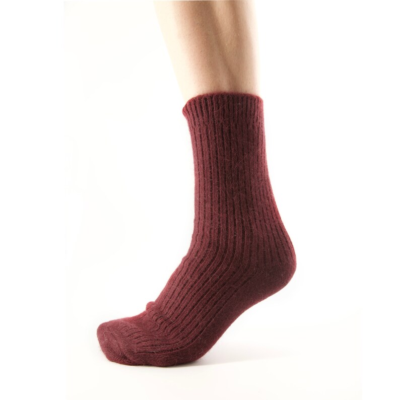 May include: A pair of maroon ribbed socks with a textured knit.