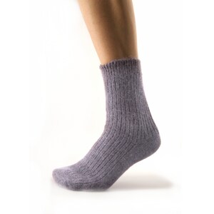 May include: A pair of soft, grey ribbed socks made from a fuzzy material.