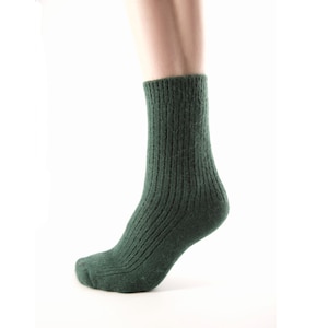 May include: A pair of dark green ribbed socks with a textured knit.