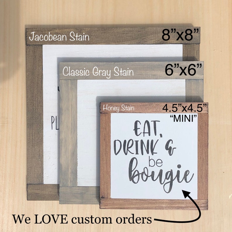 May include: Three wooden signs with different stains: Jacobean, Classic Gray, and Honey. The smallest sign is 4.5 inches by 4.5 inches and says "EAT, DRINK & be bougie".
