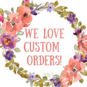 May include: A watercolour floral wreath with pink and purple flowers and green leaves surrounds the text "WE LOVE CUSTOM ORDERS!"
