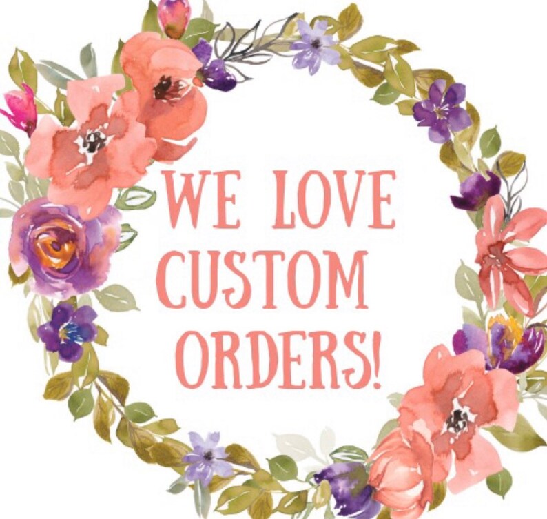 May include: A watercolour floral wreath with pink and purple flowers and green leaves surrounds the text "WE LOVE CUSTOM ORDERS!"