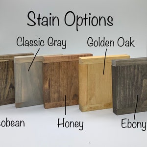May include: Five wood samples stained in different colors: Classic Gray, Golden Oak, Jacobean, Honey, and Ebony. The samples are arranged in a row from left to right.