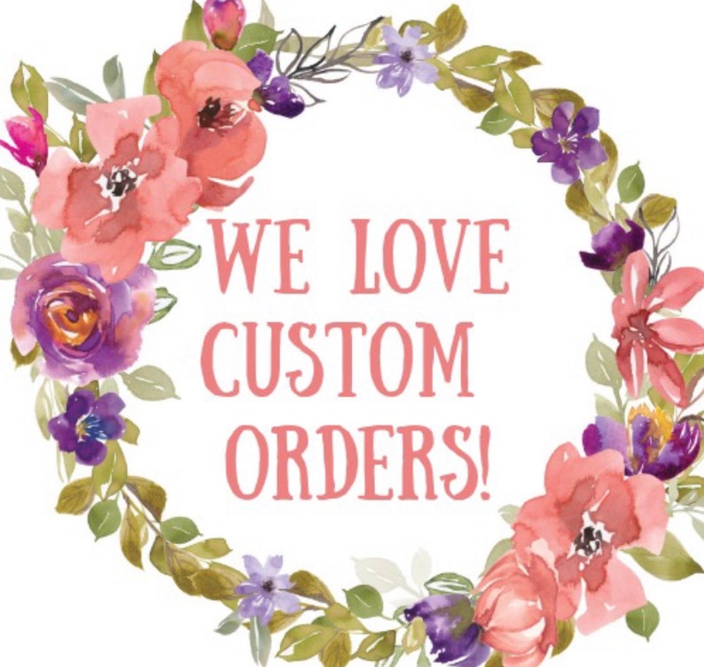 May include: A watercolor floral wreath with pink and purple flowers and green leaves. The wreath surrounds the text "WE LOVE CUSTOM ORDERS!" in pink.