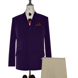 May include: A purple velvet blazer with a three-button closure, a white shirt with a black and red striped tie, a red and black patterned pocket square, and beige trousers.