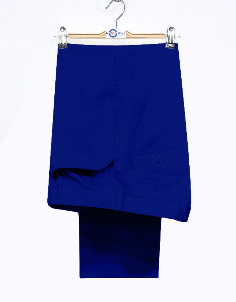 May include: A pair of royal blue dress pants hanging on a wooden hanger. The pants have a single back pocket with a button closure.