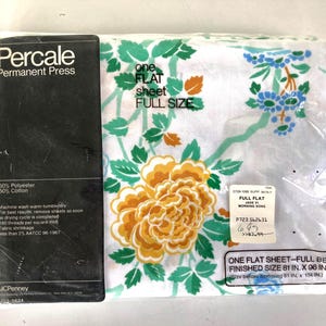May include: A full-size flat sheet in a plastic package. The sheet features a floral design with large yellow and orange flowers, green leaves, and blue accents on a white background. The packaging includes the text "Percale Permanent Press". The finished size is 81 in. x 96 in.