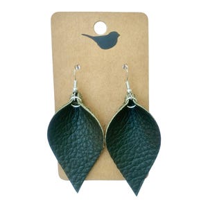 May include: A pair of dark green leather earrings shaped like teardrops, hanging from silver hooks.
