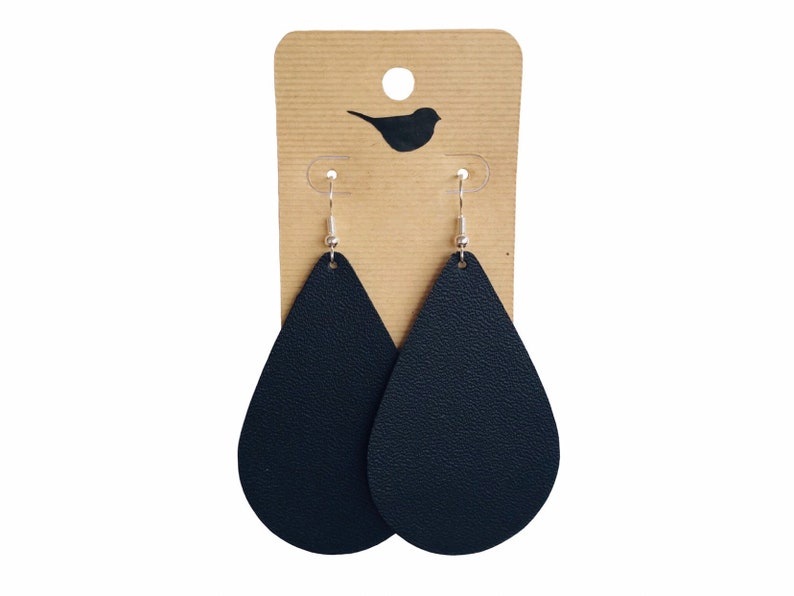 May include: A pair of black leather teardrop earrings with silver hooks.