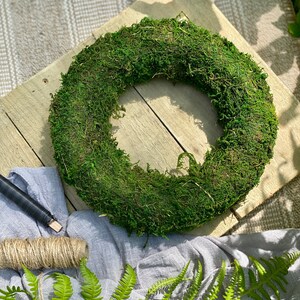 May include: A green moss wreath, perfect for adding a touch of nature to your home decor.