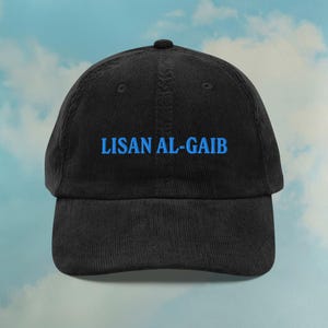 May include: Black corduroy baseball cap with blue embroidered text that reads "LISAN AL-GAIB".