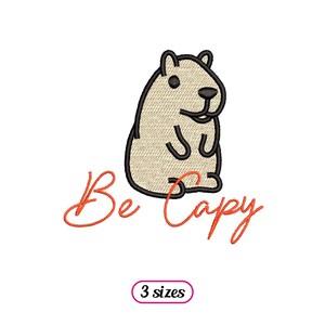 Op de afbeelding: Een cartoon capybara met zwarte contouren en een beige lichaam. De tekst "Be Capy" is in oranje onder de capybara geschreven.