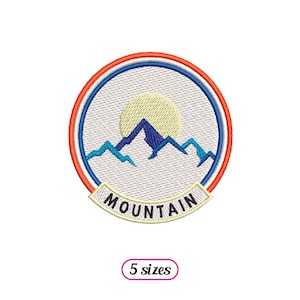 May include: Embroidered patch featuring a mountain range and sun within a circle, outlined with red, white and blue. The text "MOUNTAIN" is positioned beneath the circle.