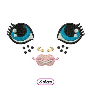 May include: Embroidered design of a cartoon face with large blue eyes, black eyelashes, a pink mouth, and black freckles. The design is available in three sizes.