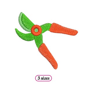 May include: An embroidered image of a pair of garden shears. The blades are green, the handles are orange, and the pivot point is red. The text "3 sizes" is in a pink oval.