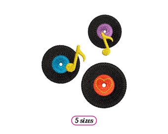 May include: Three black vinyl records with colorful designs. One record has a blue center with a yellow musical note, another has a purple center with a yellow musical note, and the third has a red heart in the center.