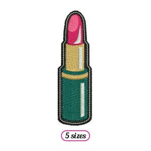 Op de afbeelding: Een geborduurde groene en gouden lipstick met een roze kogel. De lipstick heeft een zwarte omtrek.