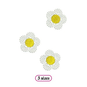 May include: Three embroidered white daisy flowers with yellow centres. The flowers are arranged in a triangular pattern. The text "3 sizes" is printed below the flowers.