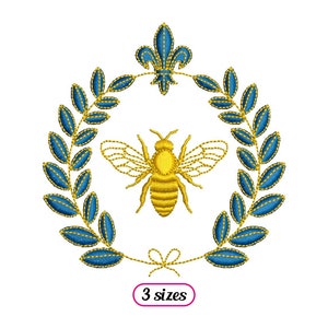 May include: Gold embroidered bee with wings, surrounded by a blue laurel wreath and a gold fleur-de-lis at the top. The design is on a white background. "3 sizes" is written in a pink rectangle at the bottom.