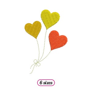 May include: Three heart-shaped balloons, one red and two yellow, tied together with a string.