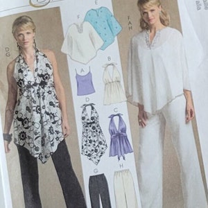 May include: McCall's Evening Elegance sewing pattern packet with images of evening wear designs. The packet is white with black text and images. A brown paper pattern and a page of instructions are also visible.