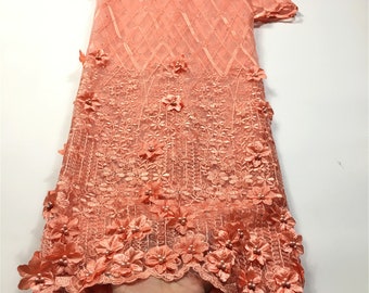 May include: Peach coloured tulle fabric with 3D floral appliques and pearl embellishments. 