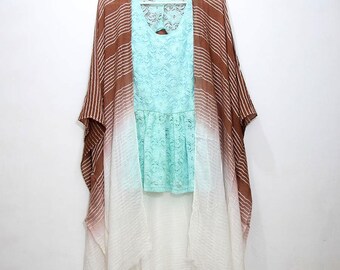 May include: A brown and white striped sheer kimono with a ombre effect. The kimono has a lace trim and is draped over a light blue lace top.