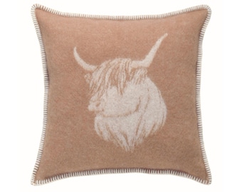 May include: Square decorative pillow with a light brown background and a white Highland cow silhouette. The pillow has a white stitched border, adding a contrasting detail to the design. The cow's head is centered, showcasing its horns and shaggy fur.