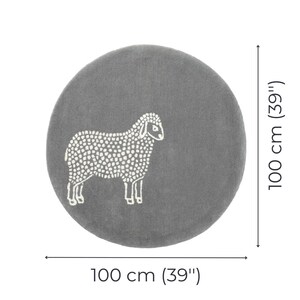 May include: A round, gray rug with a white sheep design. The rug is 39 inches in diameter. The sheep is depicted with a dotted pattern, and the rug is suitable for a nursery or children's room.