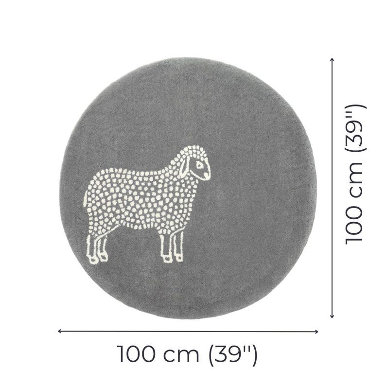 May include: A round, gray rug with a white sheep design. The rug is 39 inches in diameter. The sheep is depicted with a dotted pattern, and the rug is suitable for a nursery or children's room.