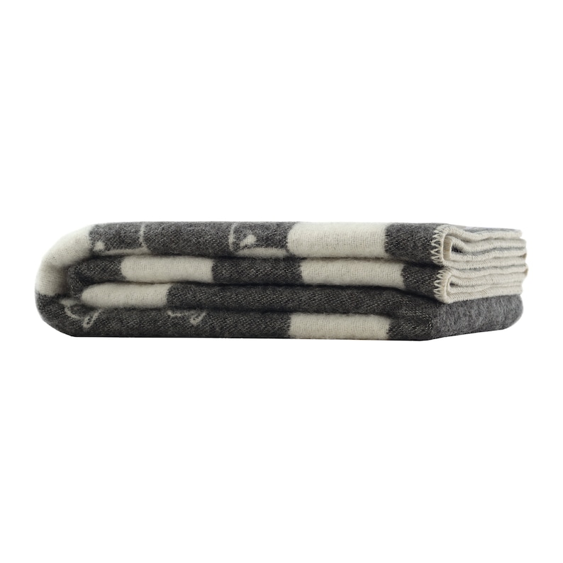 May include: A folded grey and white striped wool blanket with a subtle pattern.