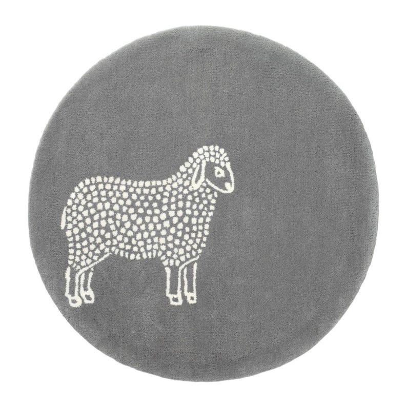 May include: A round, gray rug featuring a white sheep design. The sheep is depicted in a simple, dotted style, standing on all fours. The rug has a soft, plush texture, suitable for a child's room or nursery.
