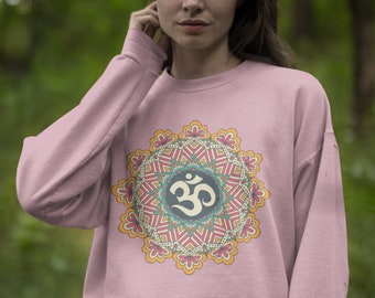 May include: A pink sweatshirt with a colourful mandala design featuring an Om symbol in the centre.