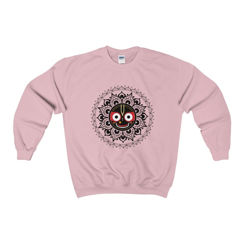 May include: Pink sweatshirt with a black and white mandala design featuring a black face with red eyes and a gold crown.