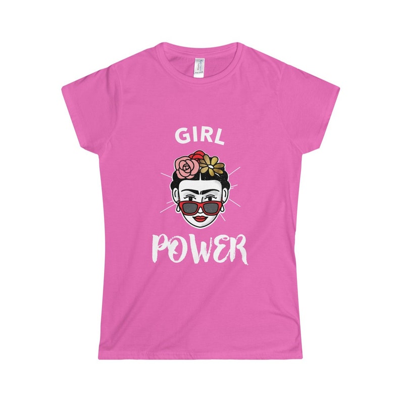 May include: Pink women's t-shirt with a white graphic of a woman with flowers in her hair and sunglasses. The text "GIRL POWER" is below the image.