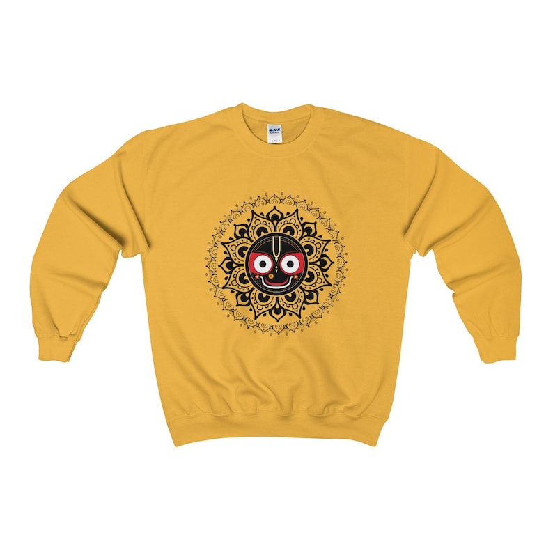 May include: A yellow sweatshirt featuring a black and red mandala design with a deity with a third eye. The mandala is surrounded by a black and white floral pattern.